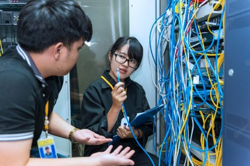 two-asian-engineers-working-server-roomcheck-connection-problems-computer-networksthailand-people_44277-4371